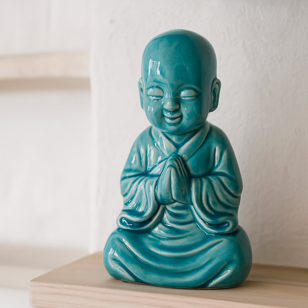 Buda de ceramica en color turquesa cara feliz